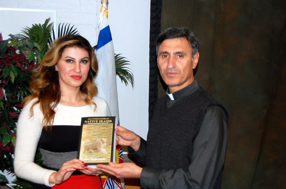 Ms. Konja and Father Gorgis with book.